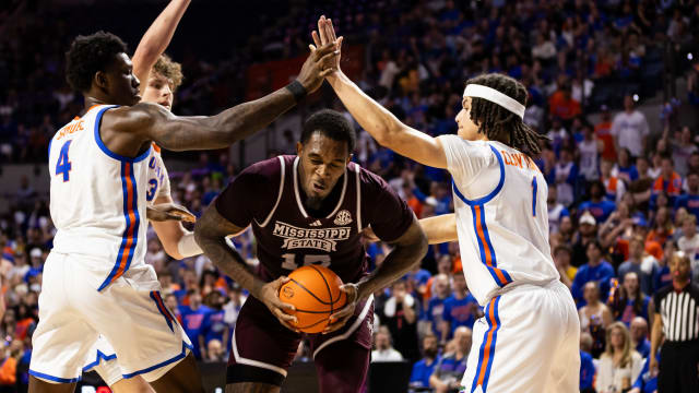 Mississippi State Bulldogs forward Jimmy Bell Jr. (15) attempts to shoot a layup over Florida Gators forward Tyrese Samuel (4) and guard Walter Clayton Jr. (1) during the first half at Exactech Arena at the Stephen C. O'Connell Center.
